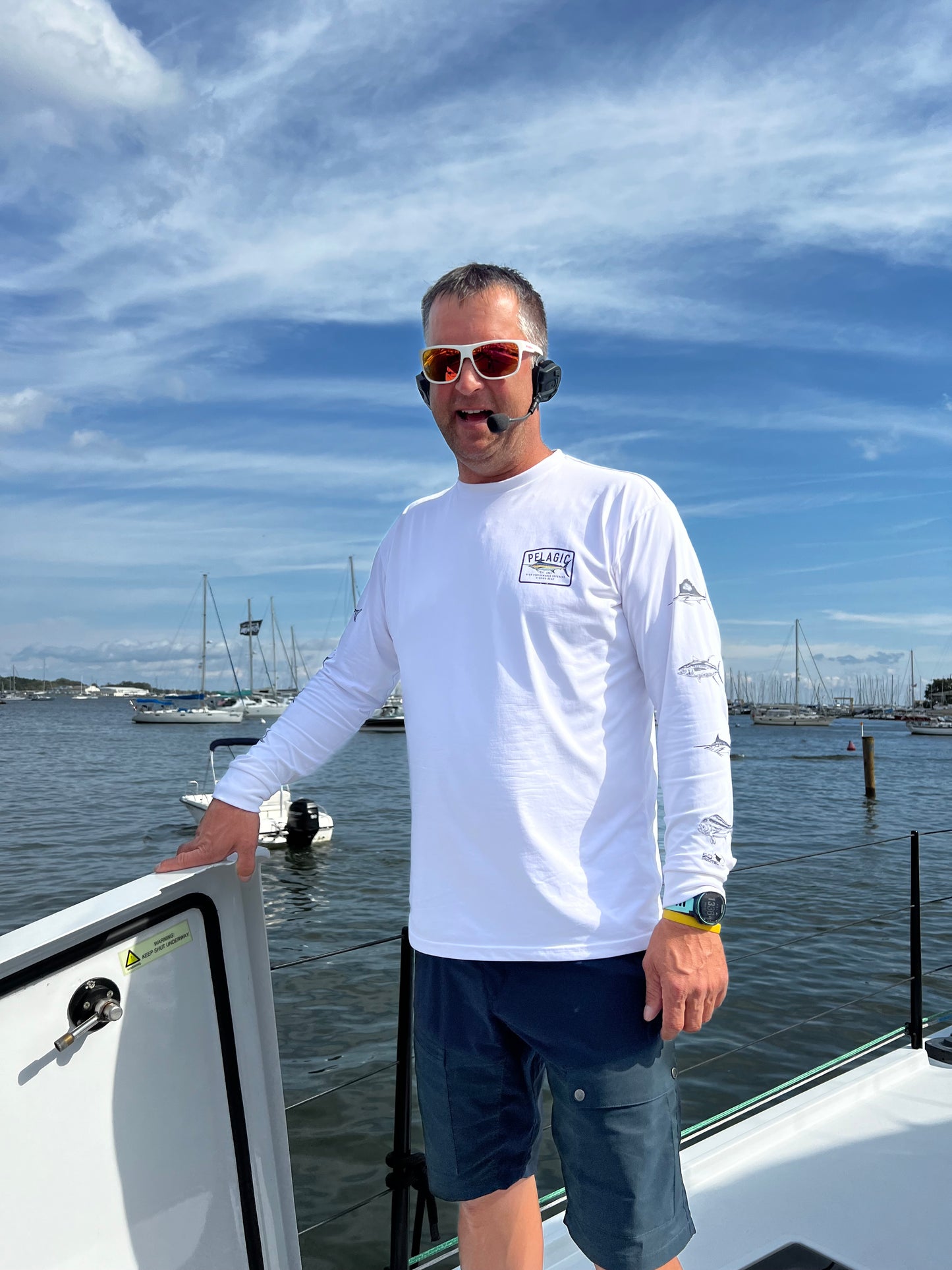 Image is of a man wearing the 2 Talk Sena expand allowing his hands to be free while performing tasks around his boat. 