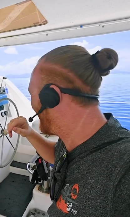 Picture shows Ian from RedSeas Sailing wearing the marriage savers 2Talks Bluetooth Headsets and how they fit behind the ear so that they do not fall off. 